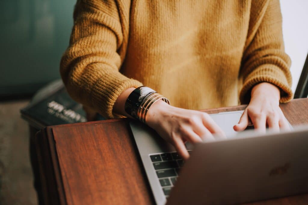 A person at their laptop submitting their CV 