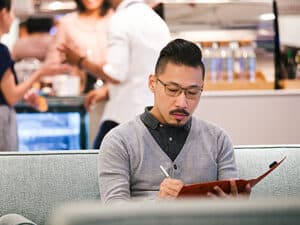 Person working on a tablet in a co-working space