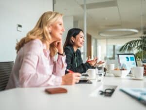 Professional women Instructing the Team at Meeting Table