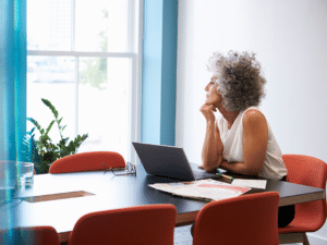 Women at desk staring out the window